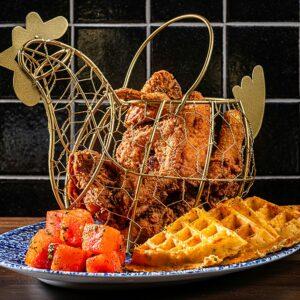 Chicken, waffles and watermelon on a blue and white plate; Vegas Super bowl classic.