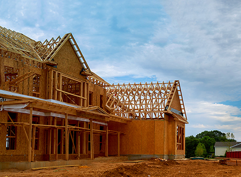 Unfinished wood frame building or framing beam of new house Central Florida Lifestyle framing beam of new home amid crowded housing market