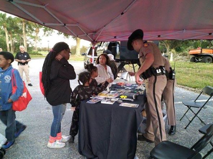 NNO - Central Florida Lifestyle photo of community members interacting with the police at National Night Out