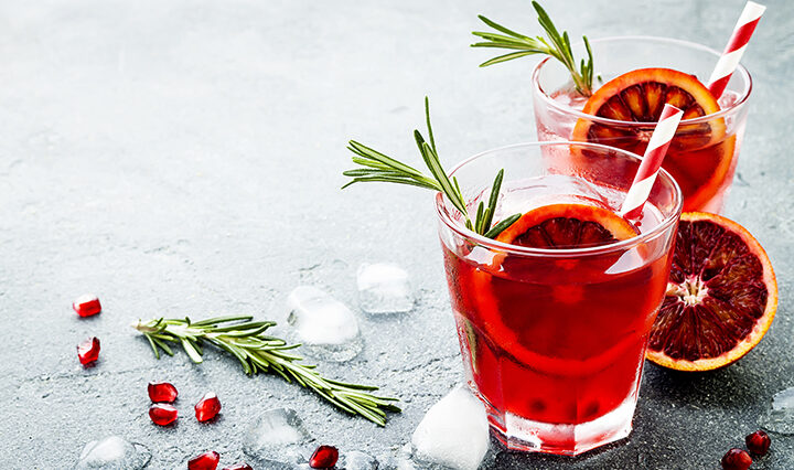 red cocktail with blood orange pomegranate. Refreshing Holiday drink