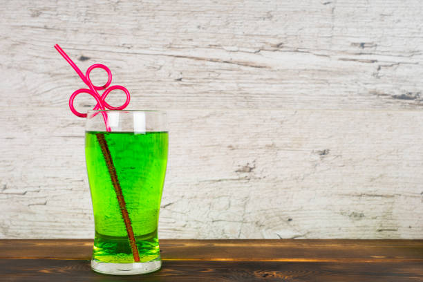 green soft drink with cocktail pipe on rustic table Central Florida Lifestyle