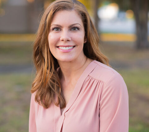 Dr. Erica Smithberger from the Clayton Dermatology Group sitting outside.
