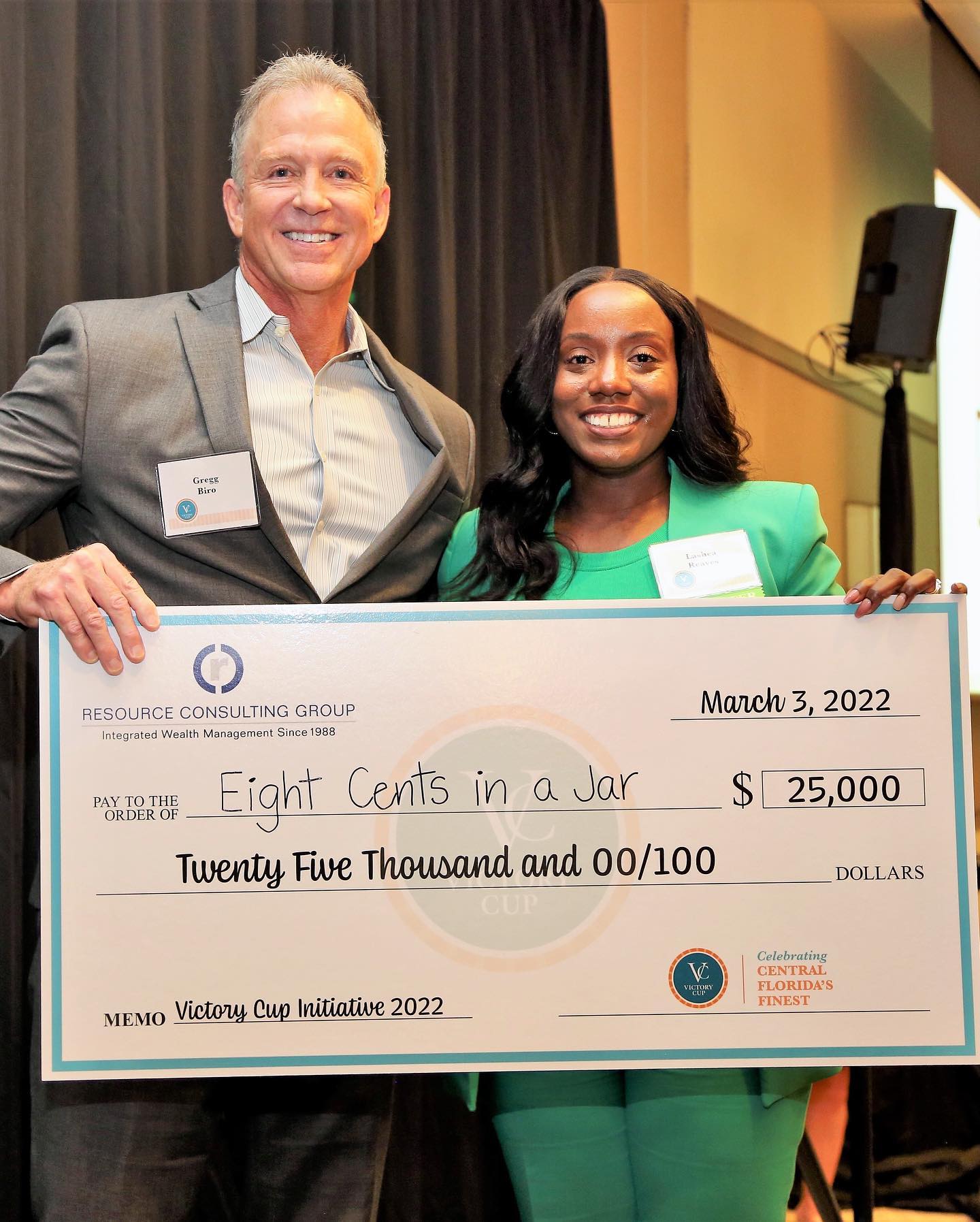 8 cents in a Jar CEO holding check she received as a winner of Victory Cup 2023.