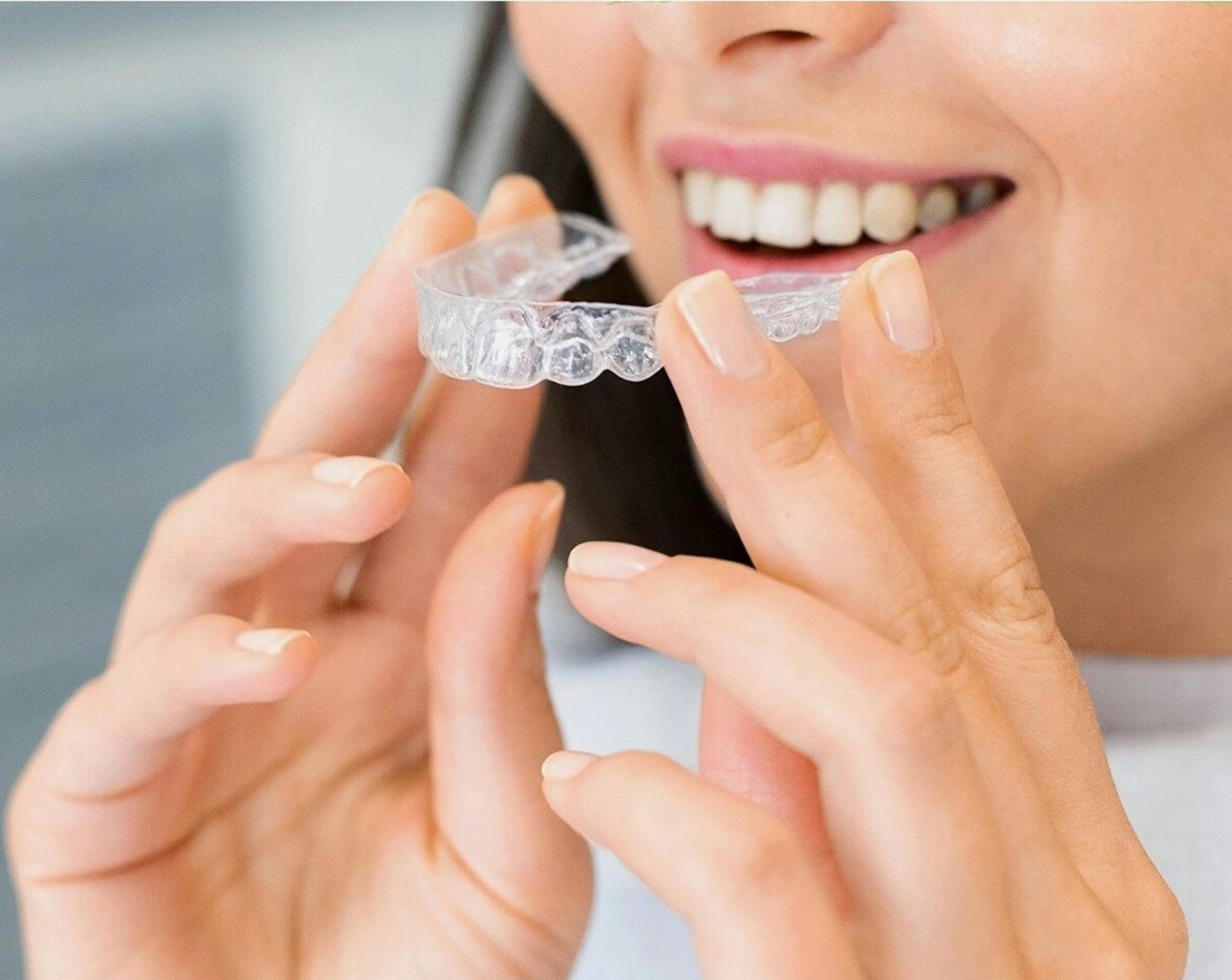 A teenager smiling with orthodontic braces